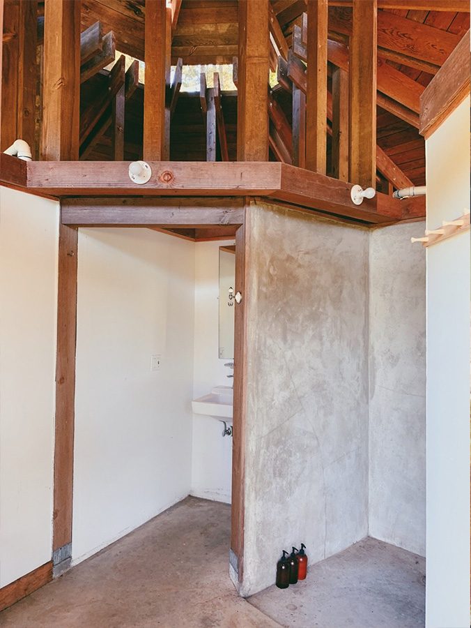Two shower stalls within the architectural pagoda with complimentary shampoo, conditioner and body wash