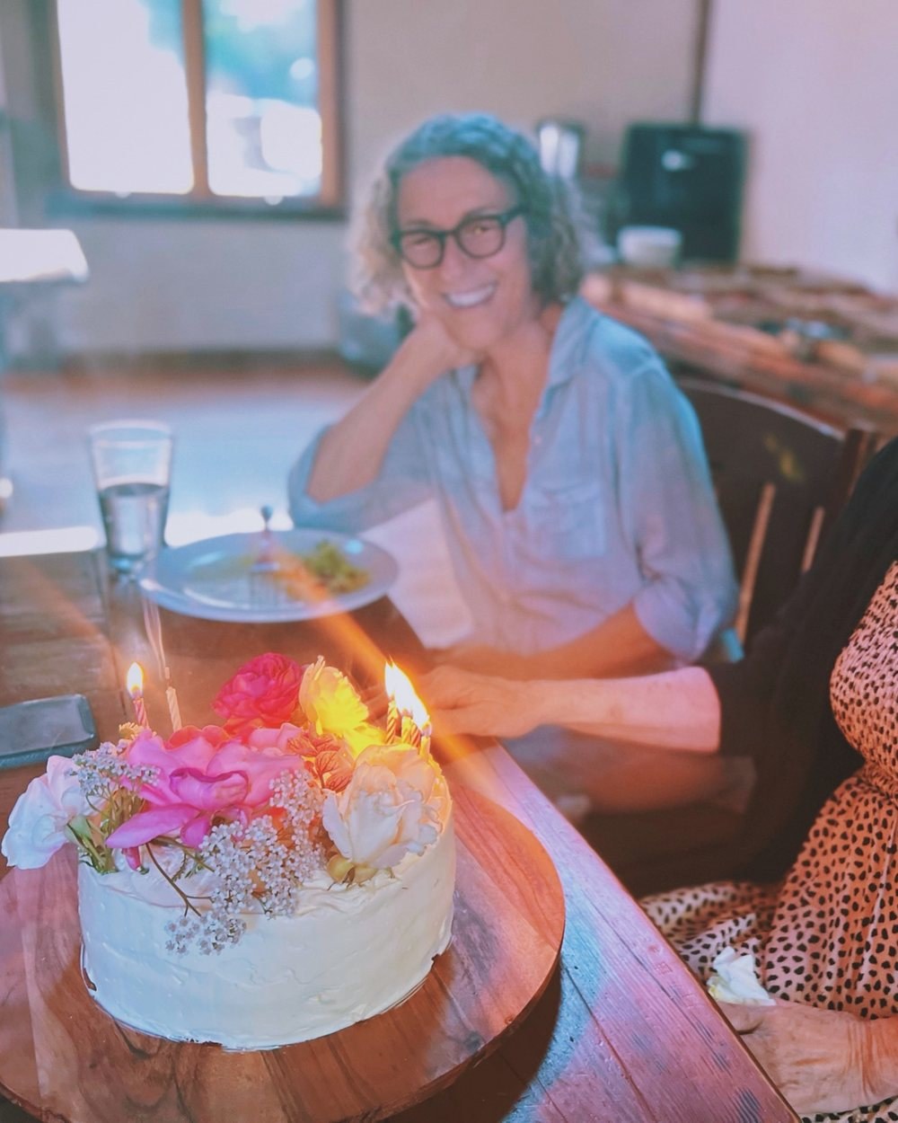 A flower-topped cake brought to the table